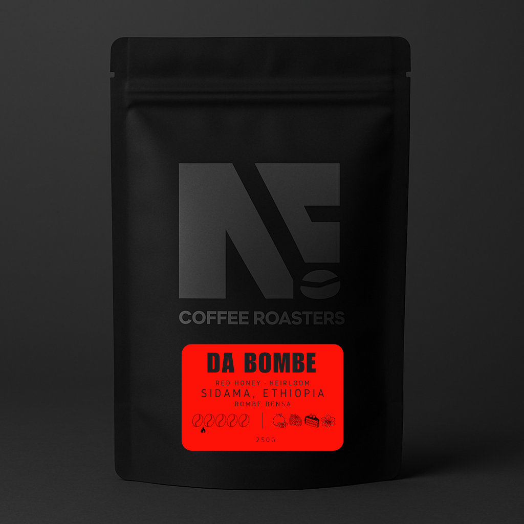 Black coffee bag with a red label featuring 'DA BOMBE' on a dark background