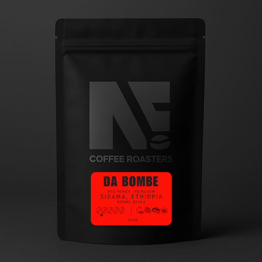 Black coffee bag with a red label featuring 'DA BOMBE' on a dark background